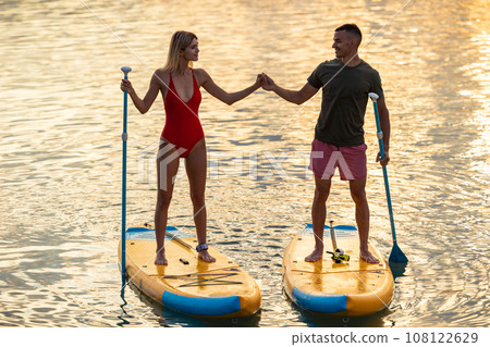 Man and woman with athletic body on surf board on river. 108122629