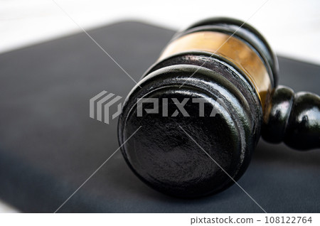 Close up of gavel on black book. Copy space and law concept. Close up of gavel on black book. Copy space and law concept. 108122764
