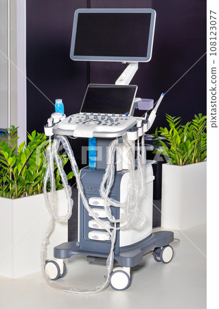 Ultrasound diagnostic system, portable ultrasound scanner on a background of green indoor plants. 108123077