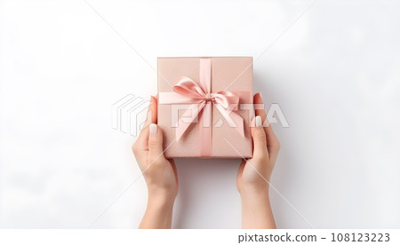 hand holding a gift box on white background hand holding a gift box on white background 108123223