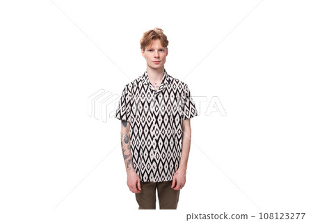 young red-haired man in a summer shirt with a rhombus print on a background with copy space young red-haired man in a summer shirt with a rhombus print on a background with copy space 108123277