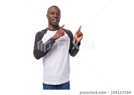 young handsome american man dressed in a long-sleeved sweater announces the news using gestures young handsome american man dressed in a long-sleeved sweater announces the news using gestures 108123584