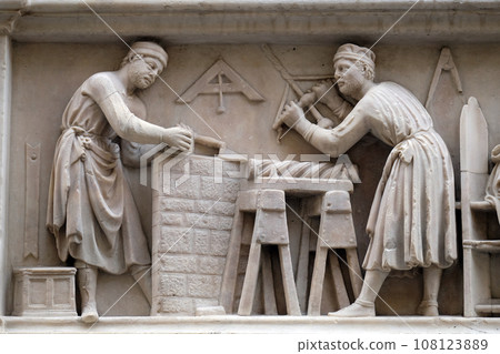 Masters of stone and timber (detail of the tabernacle of the Four Crowned Saints) by Nanni di Banco, in Orsanmichele Church in Florence, Tuscany, Italy 108123889