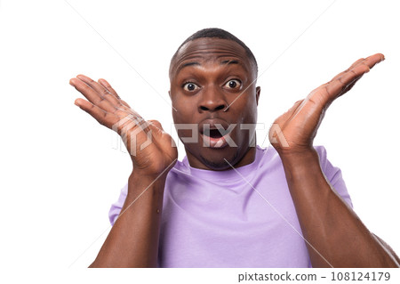 young excited american man with short haircut wearing lilac t-shirt makes a grimace young excited american man with short haircut wearing lilac t-shirt makes a grimace 108124179