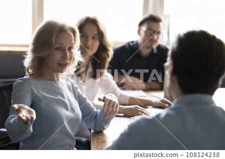 Mature business woman talks to project manager in boardroom 108124238