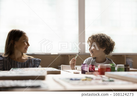 Little boy and girl engaged together in art-class 108124273