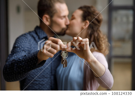 Loving millennial couple of homeowners celebrating relocation in new house 108124330