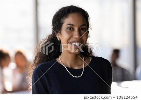 Head shot portrait smiling successful African American businesswoman in office Head shot portrait smiling successful African American businesswoman in office 108124554