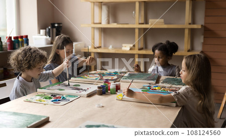 Group of little children painting pictures with paints on canvas Group of little children painting pictures with paints on canvas 108124560