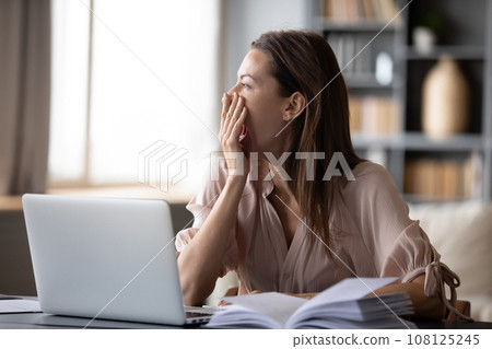 At early morning woman yawning looking out the window At early morning woman yawning looking out the window 108125245