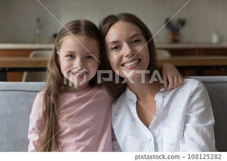 Happy mom and sweet little daughter girl home head shot Happy mom and sweet little daughter girl home head shot 108125282