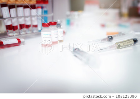 Sample of coronavirus vaccine (COVID-19) on work table in a medical lab. Sample of coronavirus vaccine (COVID-19) on work table in a medical lab. 108125390