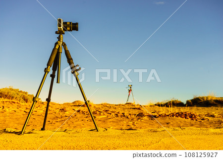 Camera on sand beach taking picture film 108125927