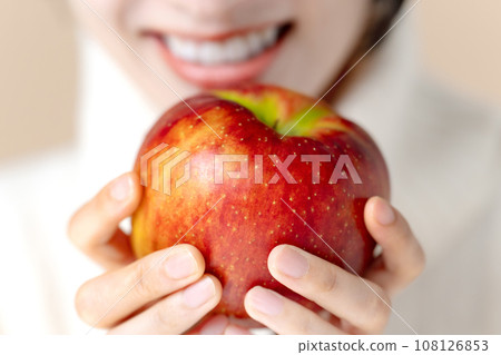 A young woman with an apple A young woman with an apple 108126853