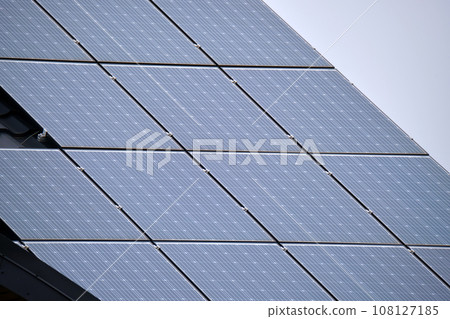 Private home roof covered with solar photovoltaic panels for generating of clean ecological electric energy in suburban rural town area. Concept of autonomous house 108127185