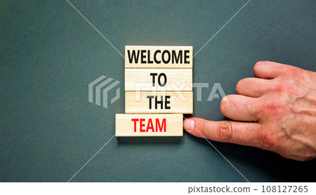 Welcome to the team symbol. Concept words Welcome to the team on wooden block. Beautiful grey table grey background. Businessman hand. Business, motivational and welcome to the team concept. 108127265
