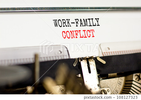 Work-family conflict symbol. Concept words Work-family conflict on white paper typed on old retro typewriter on beautiful white background. Business work-family conflict concept. Copy space. 108127323