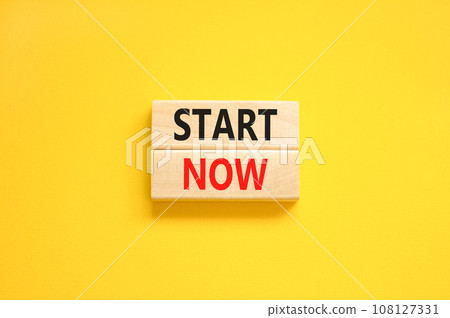 Start now symbol. Concept words Start now on beautiful wooden block. Beautiful yellow table yellow background. Business marketing, motivational start now concept. Copy space. 108127331