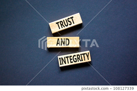 Trust and integrity symbol. Concept words Trust and integrity on wooden blocks. Beautiful grey table grey background. Business, psychological and trust and integrity concept. Copy space. Trust and integrity symbol. Concept words Trust and integrity on wooden blocks. Beautiful grey table grey background. Business, psychological and trust and integrity concept. Copy space. 108127339