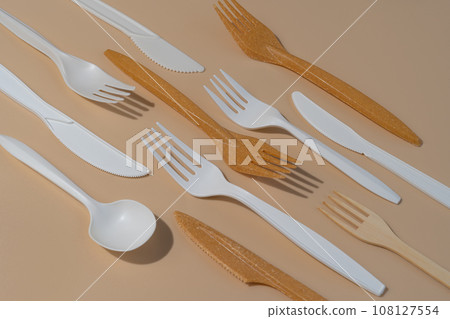 Eco friendly disposable utensils on a beige background. Eco friendly disposable utensils on a beige background. 108127554
