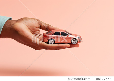Hand holding a miniature car model. Car buying, investment, insurance, protection and savings concept. Buying or selling a car, leasing business, service and repair. AI generated 108127568