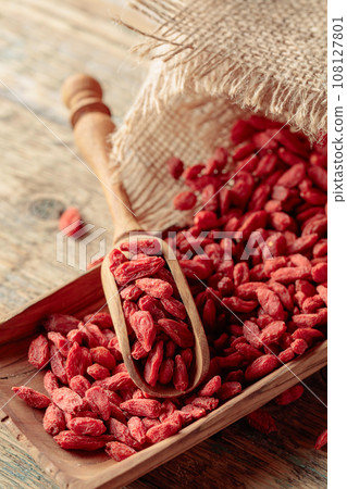 Dried goji berries on a wooden table. Dried goji berries on a wooden table. 108127801