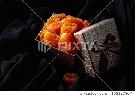 Dried apricots in a gift box. Dried apricots in a gift box. 108127807