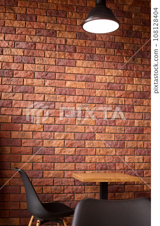 Cafe or restaurant empty table with chair loft lamp red brick wall, space for work or having lunch. Cafe or restaurant empty table with chair loft lamp red brick wall, space for work or having lunch. 108128404