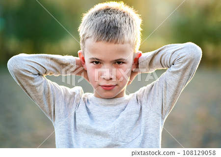 Portrait of a child boy outdoors on a warm sunny summer day. 108129058