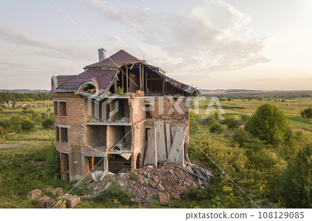 Old ruined building after earthquake. A collapsed brick house . 108129085