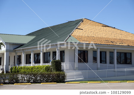 Natural disaster and its consequences. Hurricane Ian destroyed house roof in Florida residential area 108129099