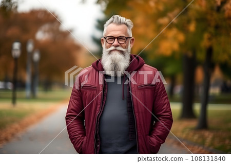 mature man in vision glasses who is happily walking through the autumn park 108131840