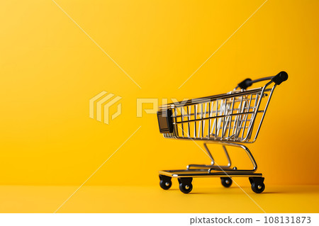 Small supermarket grocery push cart for shopping on yellow fashion background Small supermarket grocery push cart for shopping on yellow fashion background 108131873