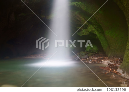 Water from a waterfall illuminated by light falling into a waterfall basin Water from a waterfall illuminated by light falling into a waterfall basin 108132596