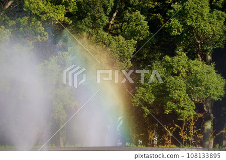 Rainbow formed in the park fountain 15 Rainbow formed in the park fountain 15 108133895