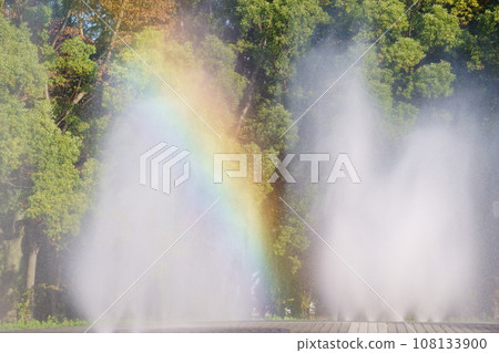 Rainbow formed in a park fountain 10 Rainbow formed in a park fountain 10 108133900