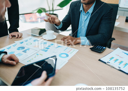 Asian business advisor meeting to analyze and discuss the situation on the financial report in the meeting room.Investment Consultant, Financial , teamwork ,brainstorming ,startup and accounting. 108135752