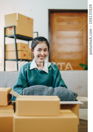 Starting small business entrepreneur of independent Asian female online seller packing products to send to customers and SME delivery concept. Starting small business entrepreneur of independent Asian female online seller packing products to send to customers and SME delivery concept. 108135826