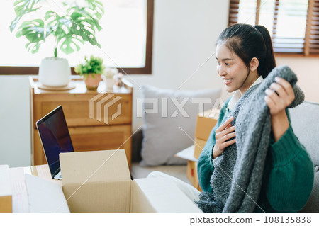 Beautiful Asian woman, blogger, blog, presenting fashion clothes, live video, social media, record her, sell online via digital cameras, sme or small business ecommerce concepts. 108135838