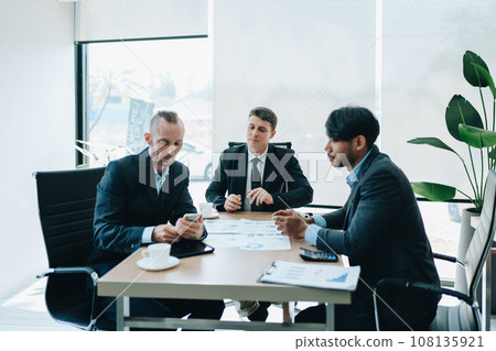Asian business advisor meeting to analyze and discuss the situation on the financial report in the meeting room.Investment Consultant, Financial , teamwork ,brainstorming ,startup and accounting. 108135921
