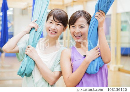 Young woman doing aerial yoga at the gym Young woman doing aerial yoga at the gym 108136120