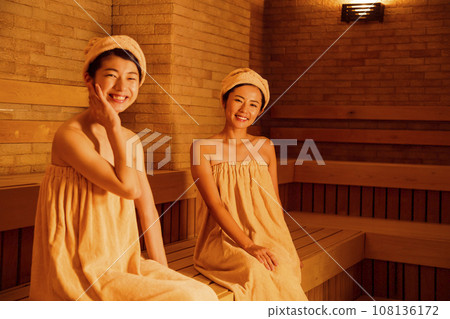 Young woman entering a sauna Young woman entering a sauna 108136172