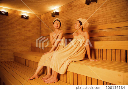 Young woman entering a sauna 108136184