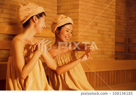 Young woman entering a sauna Young woman entering a sauna 108136185