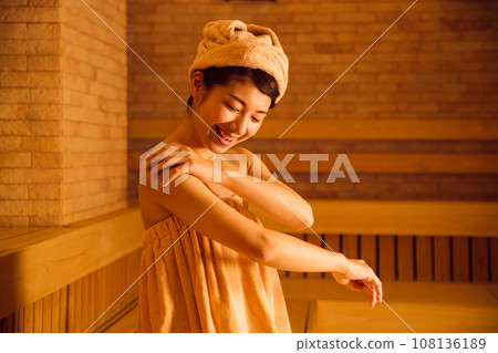 Young woman entering a sauna Young woman entering a sauna 108136189