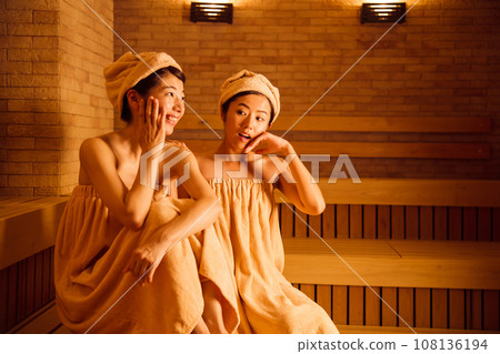Young woman entering a sauna Young woman entering a sauna 108136194