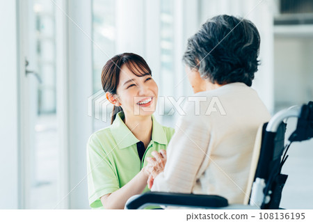 A senior woman in a car and a care worker 108136195