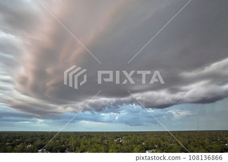 Cumulonimbus clouds forming before thunderstorm on evening sky. Changing stormy cloudscape weather at sunset 108136866