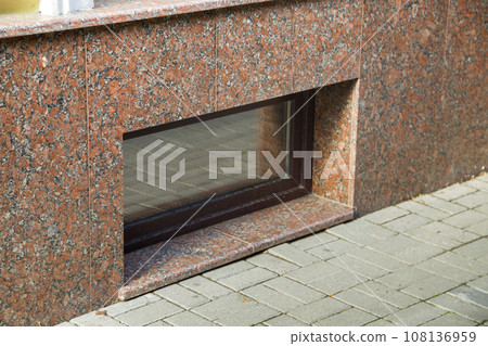 Close up view of part of a building facade with the surface of granite wall. Natural stone materials. 108136959