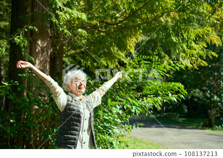 A woman enjoying forest bathing A woman enjoying forest bathing 108137213